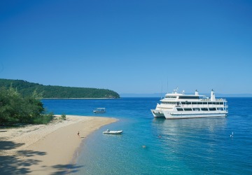 Great Barrier Reef Cruise ship moored near tropical island