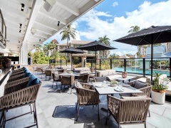 Enjoy alfresco dining with views of the Lagoon Swimming Pool | Novotel Oasis Resort Cairns