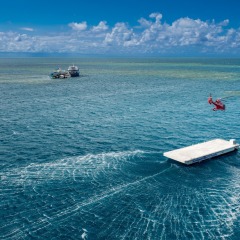 Helicopter landing on the pontoon out on the Great Barrier Reef off Cairns