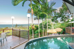 Swim in a pool with views to the Coral Sea and Cairns | Palm Cove Luxury Holiday Home