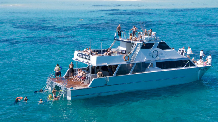 Scuba diving off the back of the boat - hydraulic platform eases you to the water level