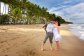 Wedding couple having photos taken on the beach in Port Douglas 